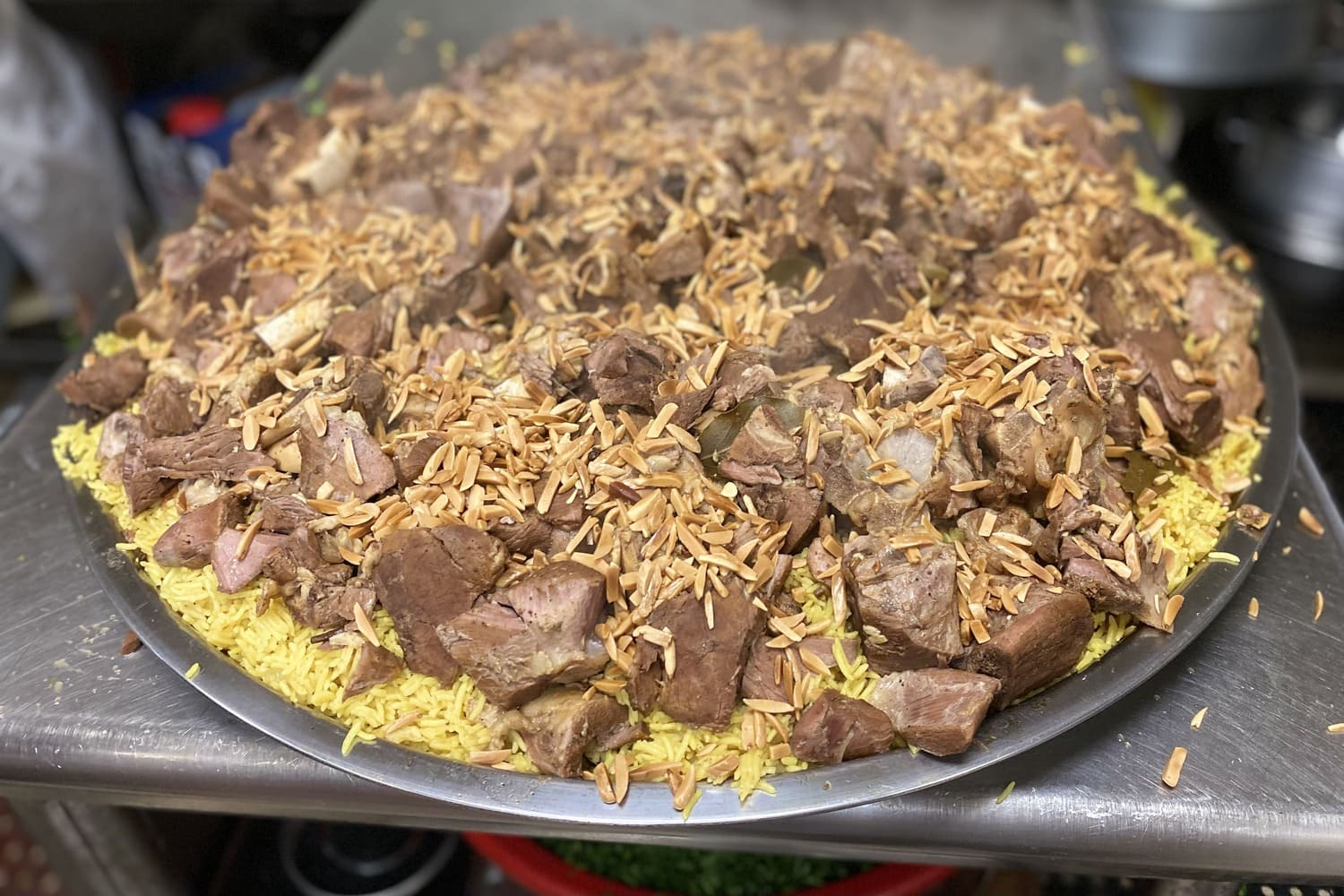 Large tray of lamb over saffron rice with toasted almonds