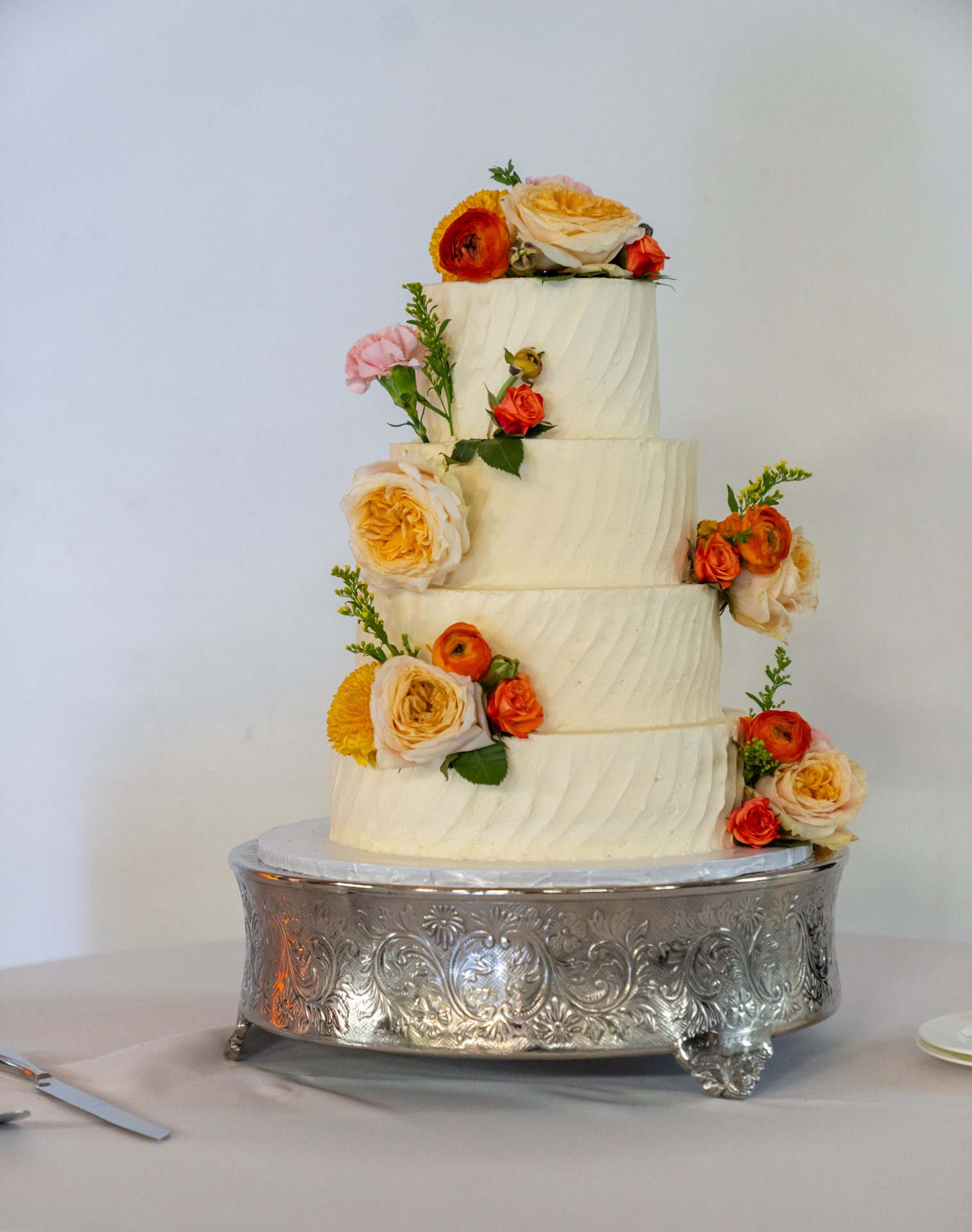 Four-tier wedding cake with garden roses