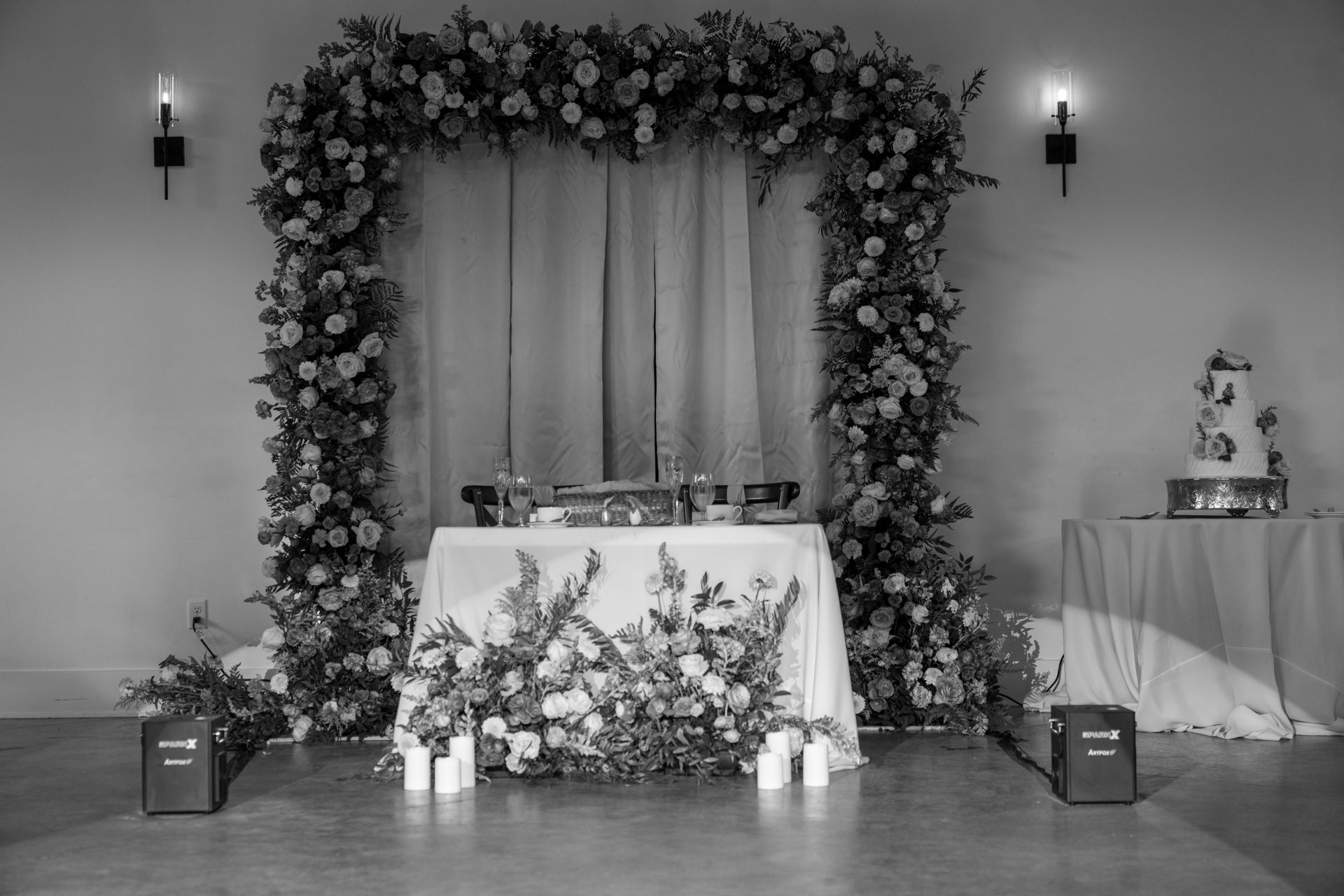 Rooftop welcome dinner with low florals and hanging bulb lights