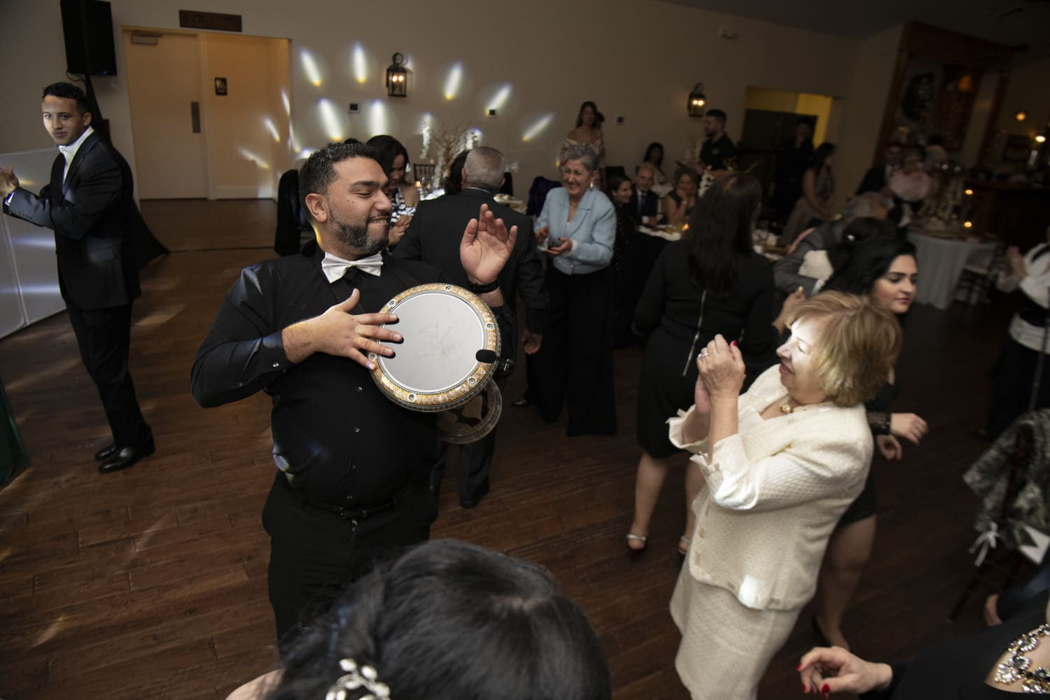 Guests pulled into the dabke line under warm reception lighting