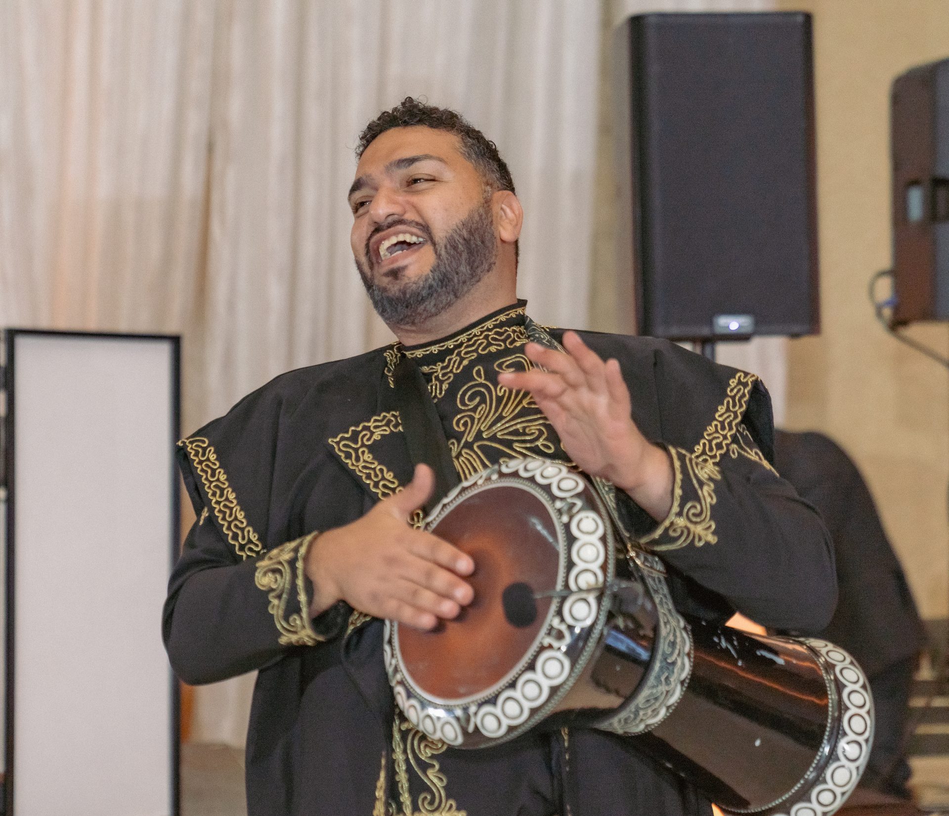 ZEO percussionist playing the darbuka in traditional dress during the sahra