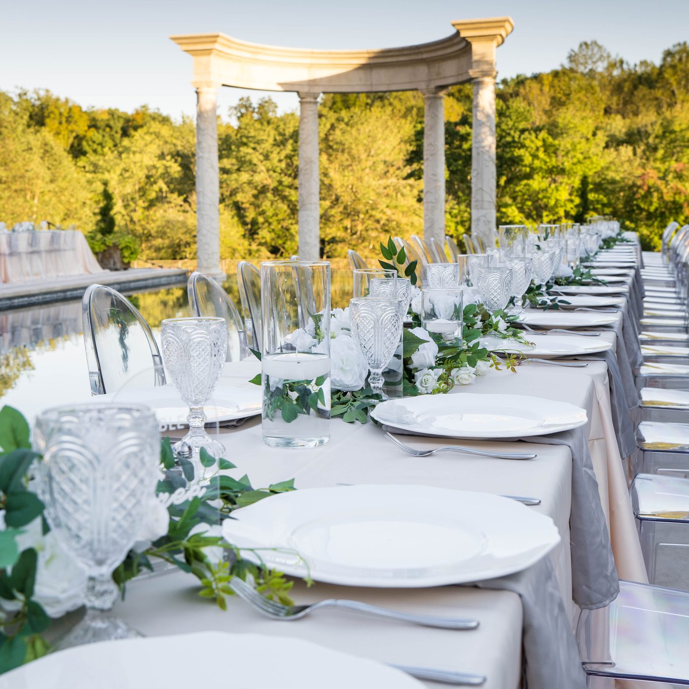 Annapolis waterfront ceremony with a white arch and Bay behind