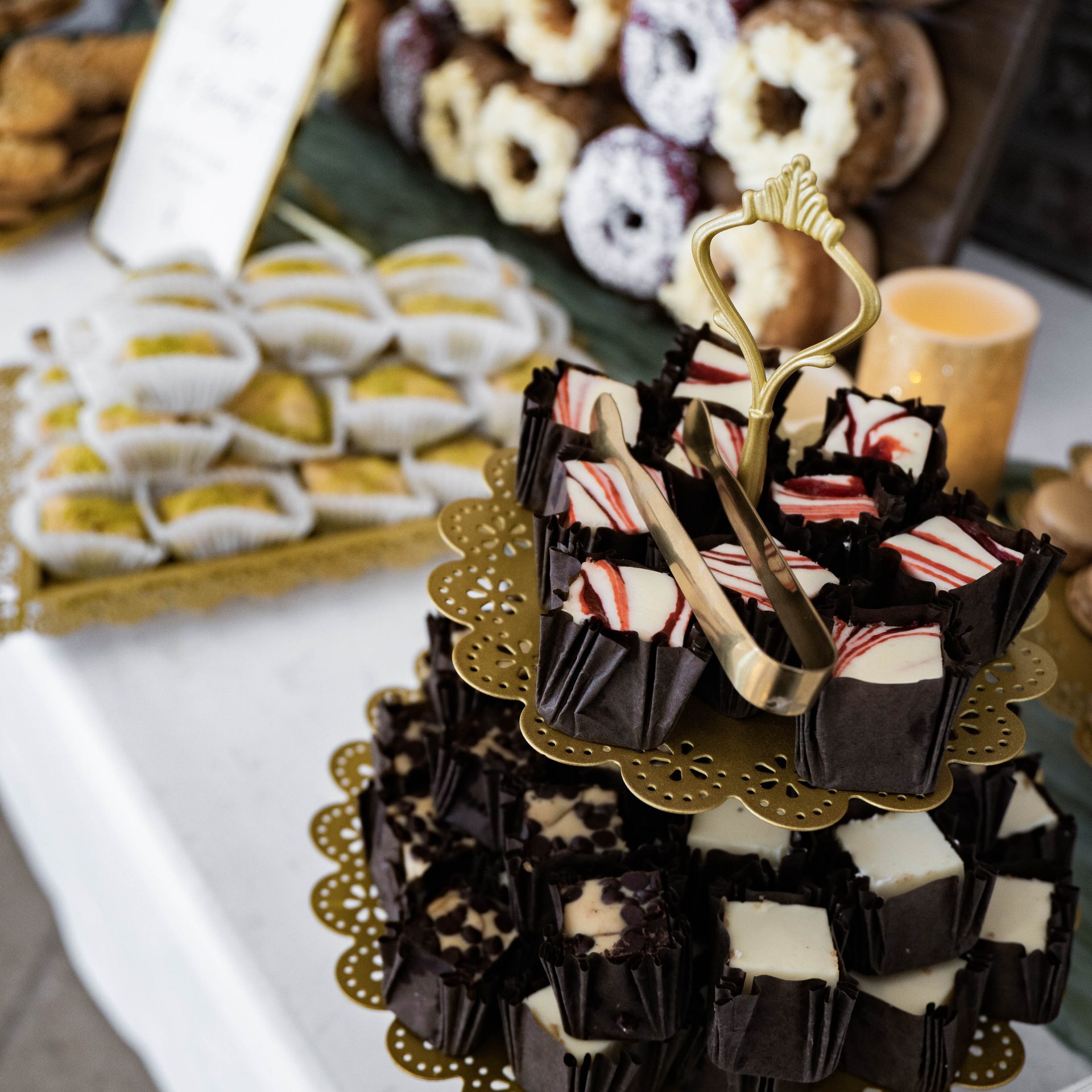 Tiered dessert tower with petit fours, peppermint cups and chocolate treats