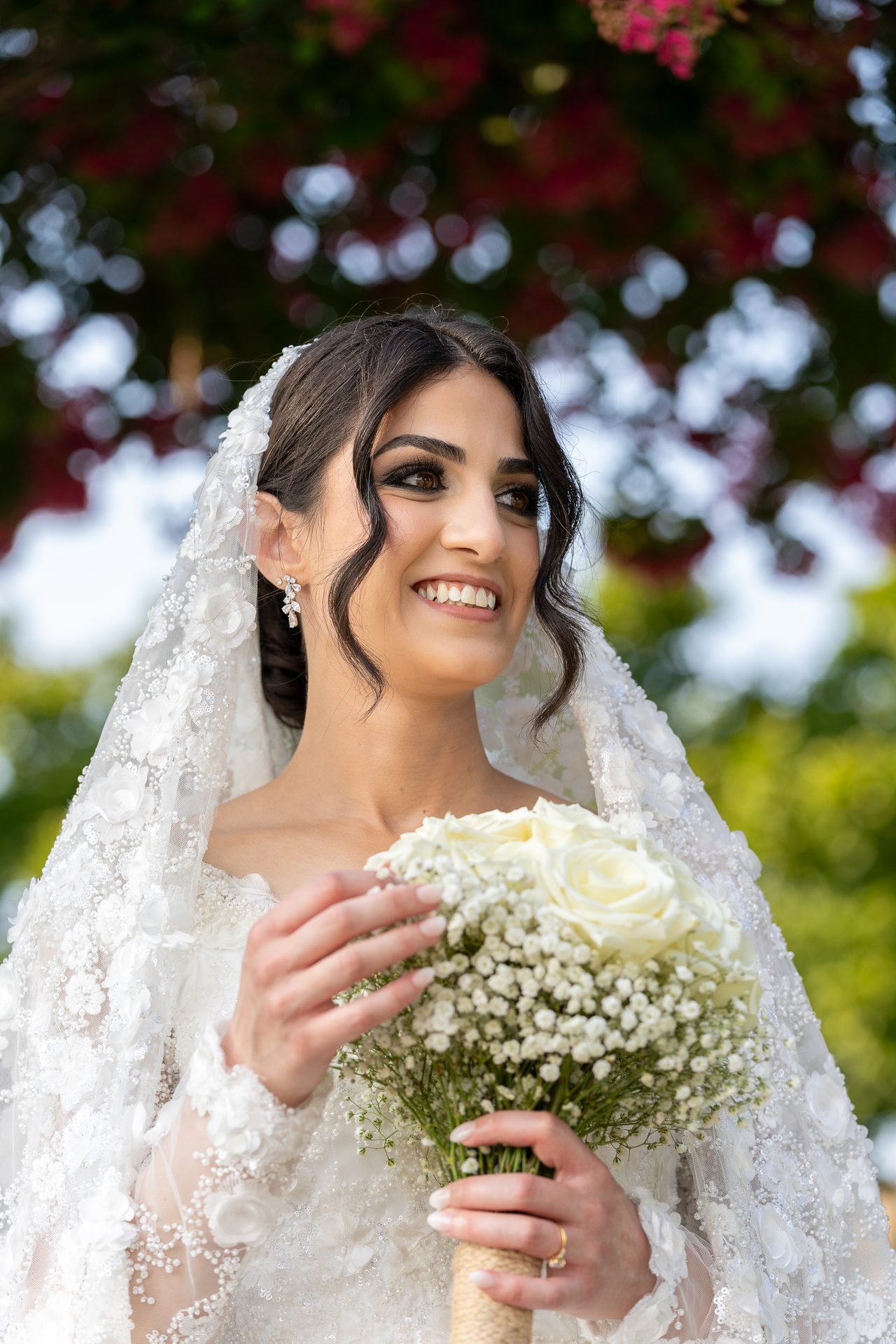 Bride portrait smiling with a white rose bouquet