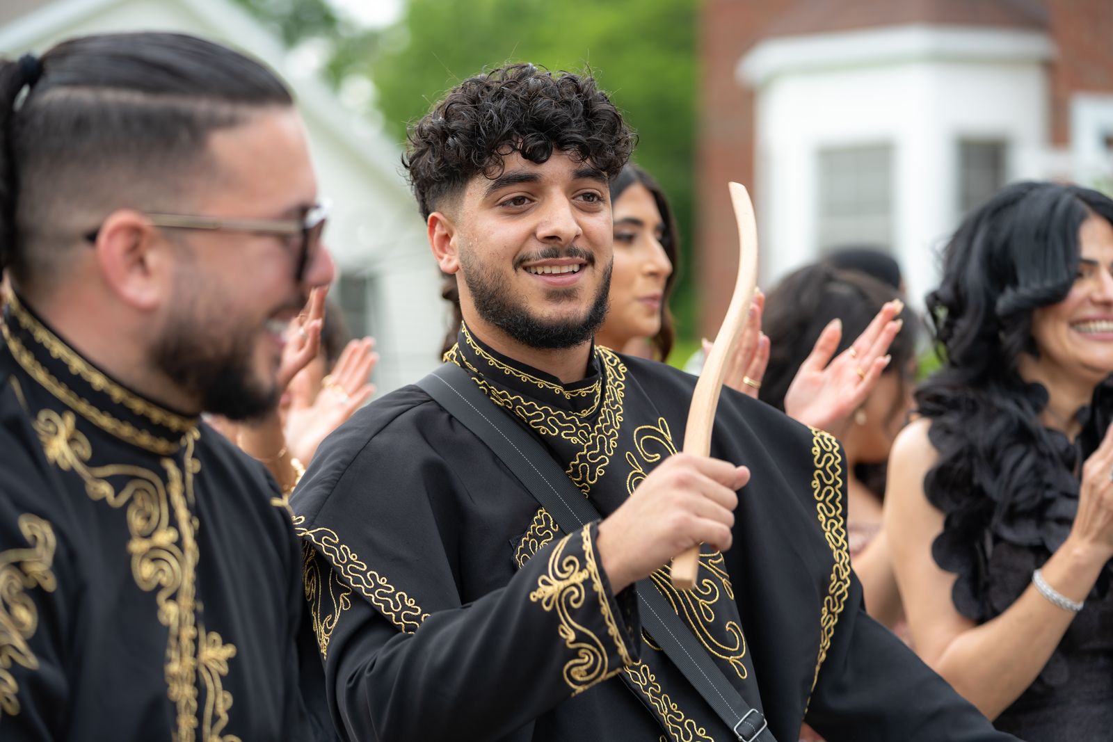 The ZEO drumline lined up in gold-embroidered outfits before the entrance